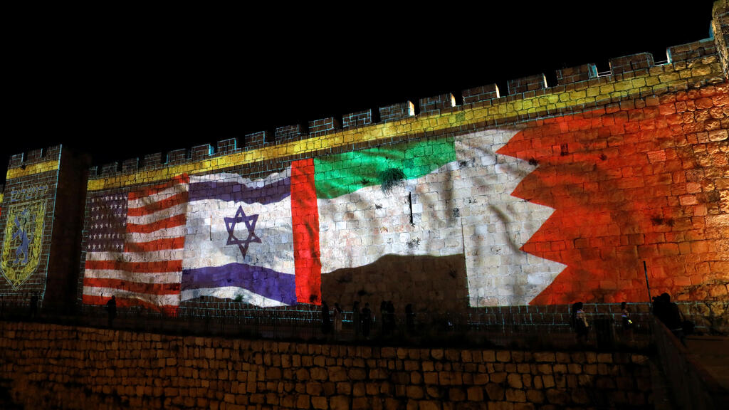 The flags of the United States, Israel, United Arab Emirates and Bahrain are projected on a section of the walls surrounding Jerusalem's Old City