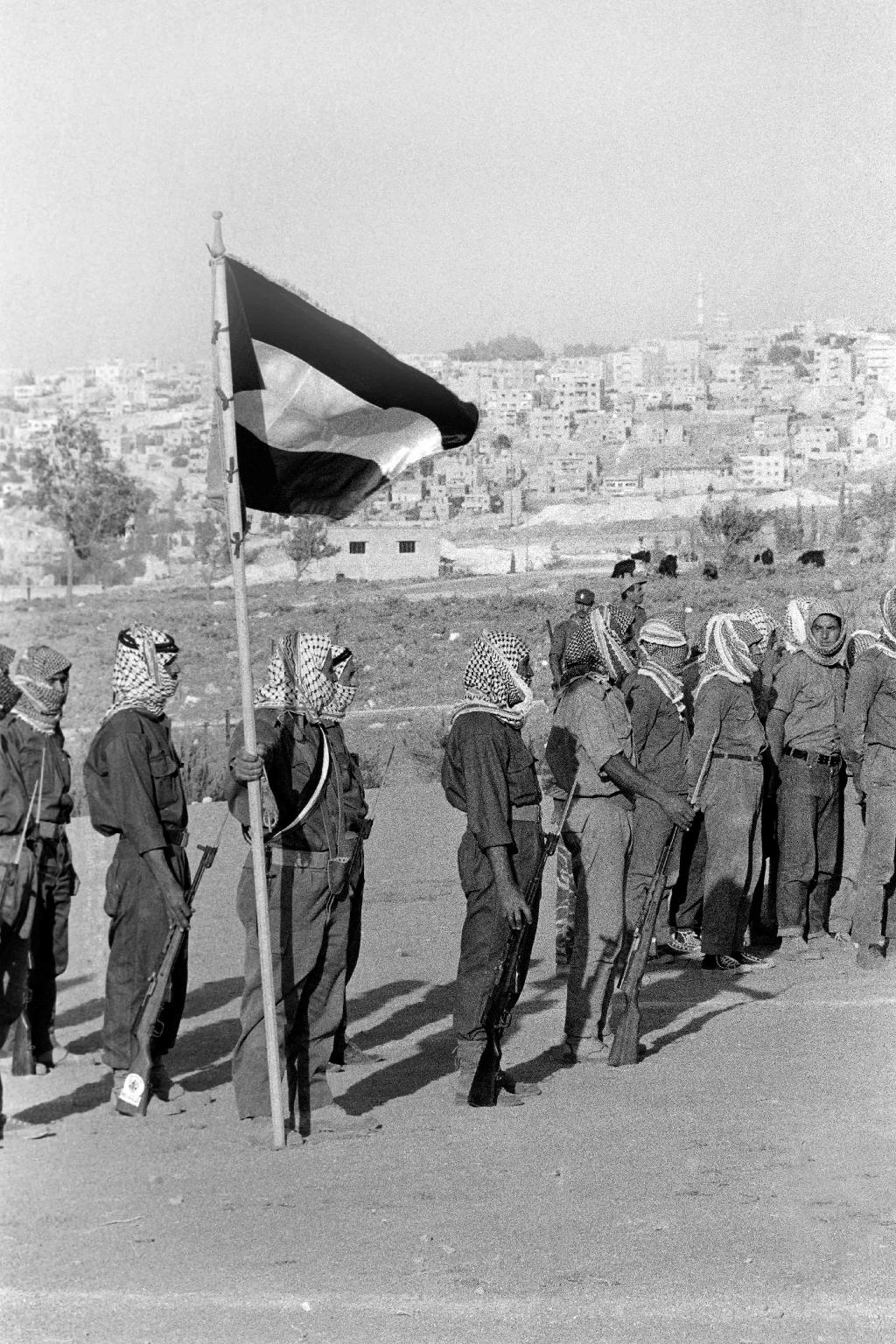 In this file photograph taken on August 17, 1970, militiamen of El Fatah Palestinian resistance movement, parade in Amman, Jordan, at the end of a training session chaired by Yasser Arafat, President of the Central Committee of the Palestinian National Council 