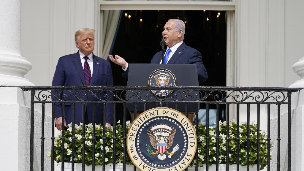 Israeli Prime Minister Benjamin Netanyahu speaks as President Donald Trump looks on, during the Abraham Accords signing ceremony
