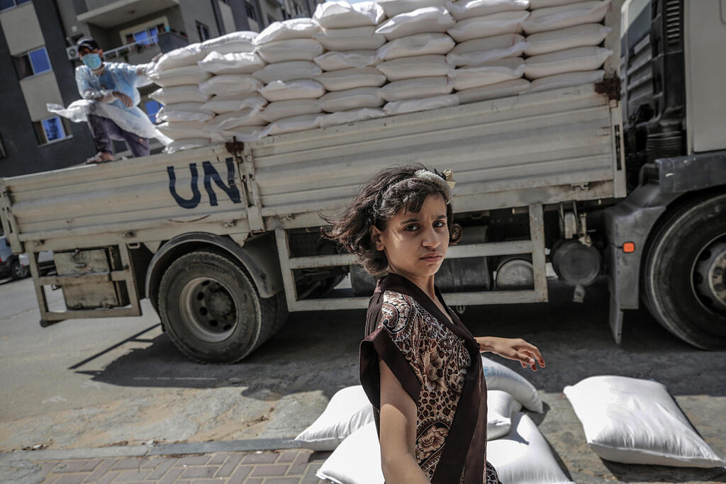  A Palestinian child waits to recieve food applies with her family from the United Nation Relief and Works Agency (UNRWA)