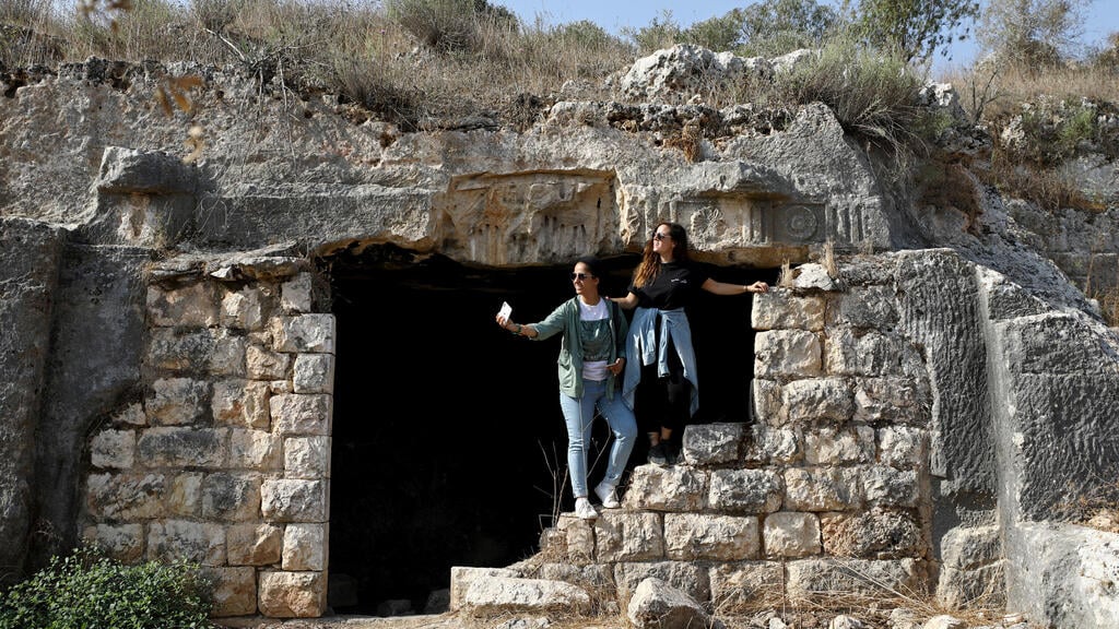 oung Palestinian travel bloggers Malak Hasan and Bisan Alhajhasan sit at the remains of an archeological site in the village of Aboud near Ramallah 