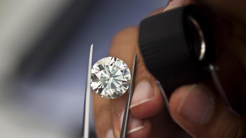 A trader inspects a diamond during a show at the trading floor of Israel's Diamond Exchange (IDE) in Ramat Gan near Tel Aviv,