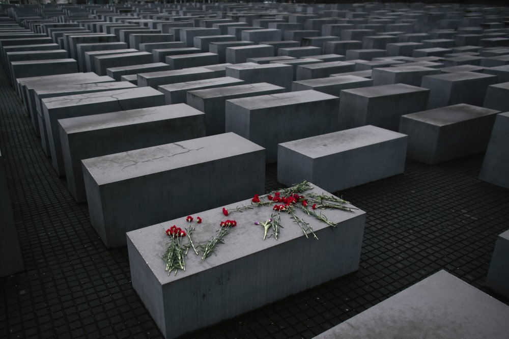  flowers lie on a concrete slab of the Holocaust Memorial to mark the International Holocaust Remembrance Day and commemorating the 70th anniversary of the liberation of the Nazi Auschwitz death camp in Berlin 