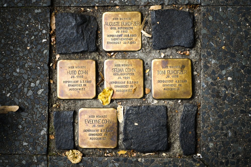 So called stumbling blocks, marking the last voluntarily chosen places of residence of the victims of the Nazis, are embedded in the pavement in Berlin, Germany 