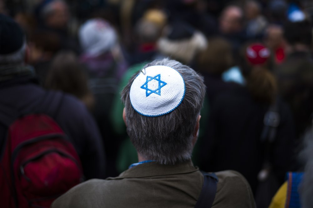 A man wears a Yamaka, as he attends a demonstration against an anti-Semitic attack in Berlin 