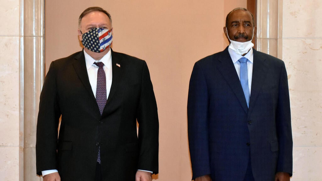 US Secretary of State Mike Pompeo (L) poses for a picture with Sudan's Sovereign Council chief General Abdel Fattah al-Burhan in Khartoum
