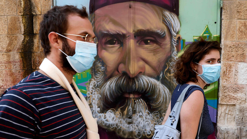  People wearing masks in Jerusalem's Mahane Yehuda market last month 