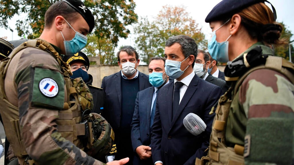 French Interior Minister Gerald Darmanin, center left, Joel Mergui, center left behind , President of the Israelite Central Consistory of France talk with soldiers before a visit to the synagogue of Boulogne-Billancourt 