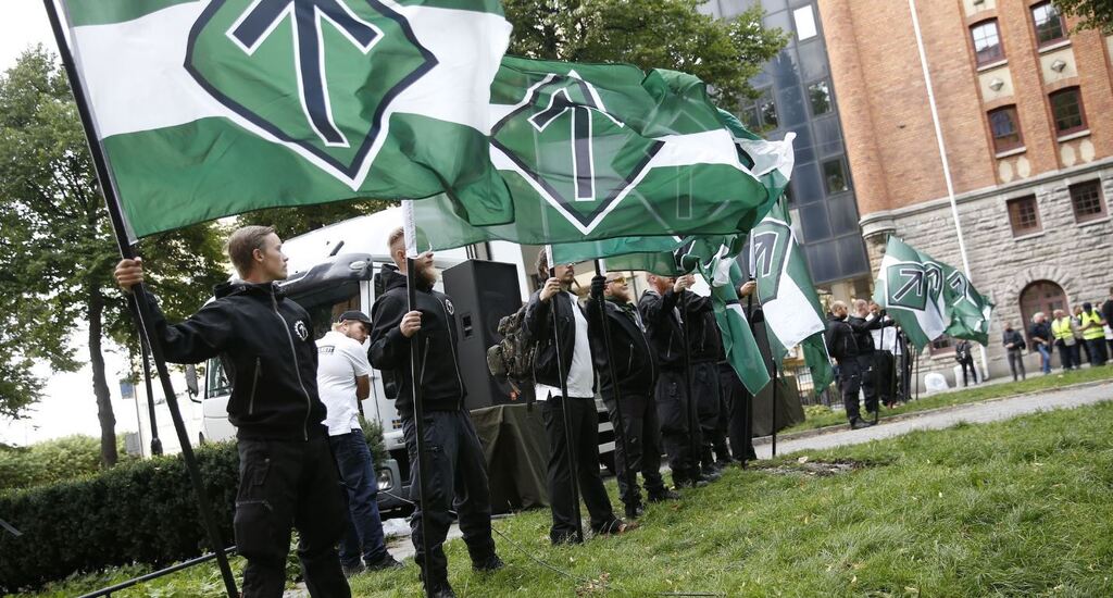  Supporters of the neo-Nazi Nordic Resistance Movement hold flags during a demonstration at the Kungsholmstorg square in Stockholm
