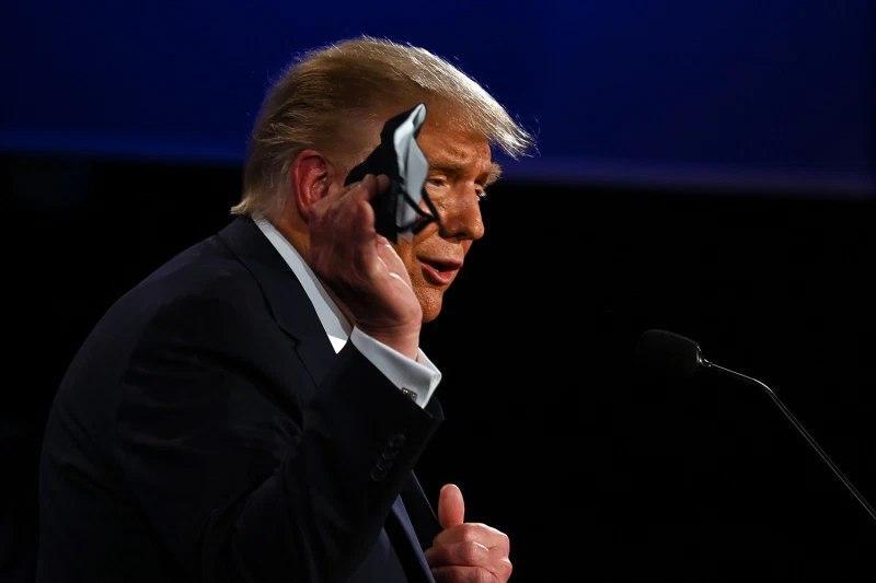 .S. President Donald Trump holds a face mask as he speaks during the first presidential debate in Cleveland, Ohio, on Sept. 29
