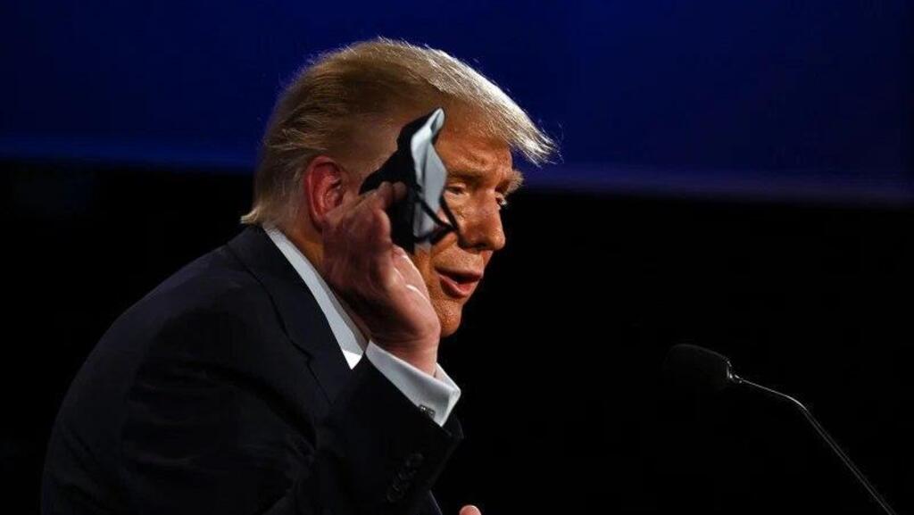 .S. President Donald Trump holds a face mask as he speaks during the first presidential debate in Cleveland, Ohio, on Sept. 29