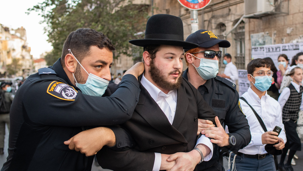 Police arrest an ultra-Orthodox man during a protest against coronavirus health mitigations in Jerusalem in October (Photo: Shalom Shalev) מחאות בירושלים
