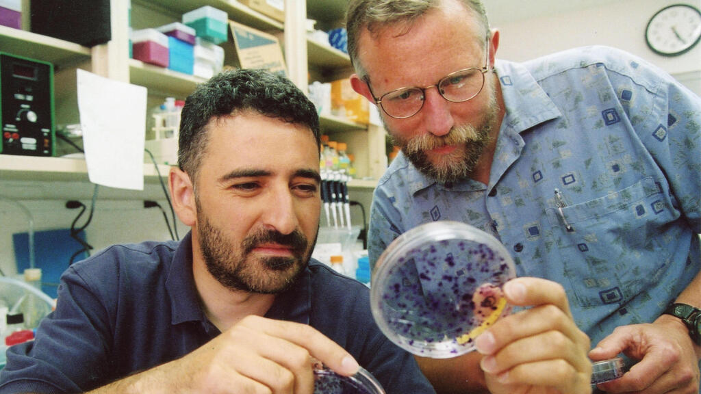 Charles M. Rice(R) with a student in a lab