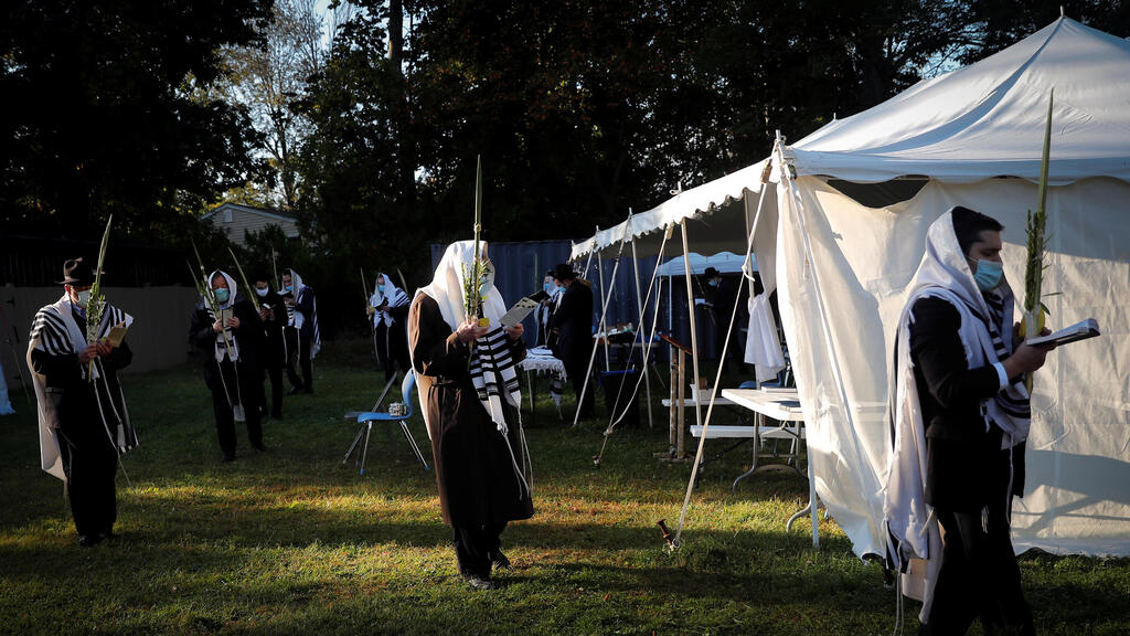 Orthodox Jews gather for "Hoshanot prayers" as part of their Sukkot observance on a neighborhood lawn to avoid over-crowding at an indoor synagogue, following the outbreak of the coronavirus disease (COVID-19) in the New York City suburb of Monsey 