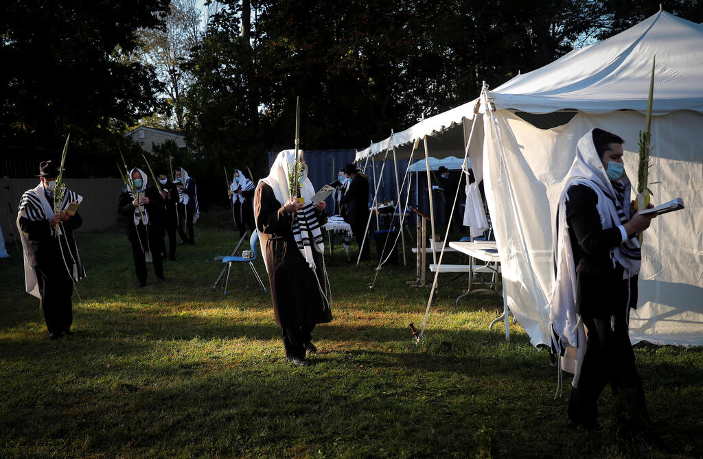 Orthodox Jews gather for "Hoshanot prayers" as part of their Sukkot observance on a neighborhood lawn to avoid over-crowding at an indoor synagogue, following the outbreak of the coronavirus disease (COVID-19) in the New York City suburb of Monsey 
