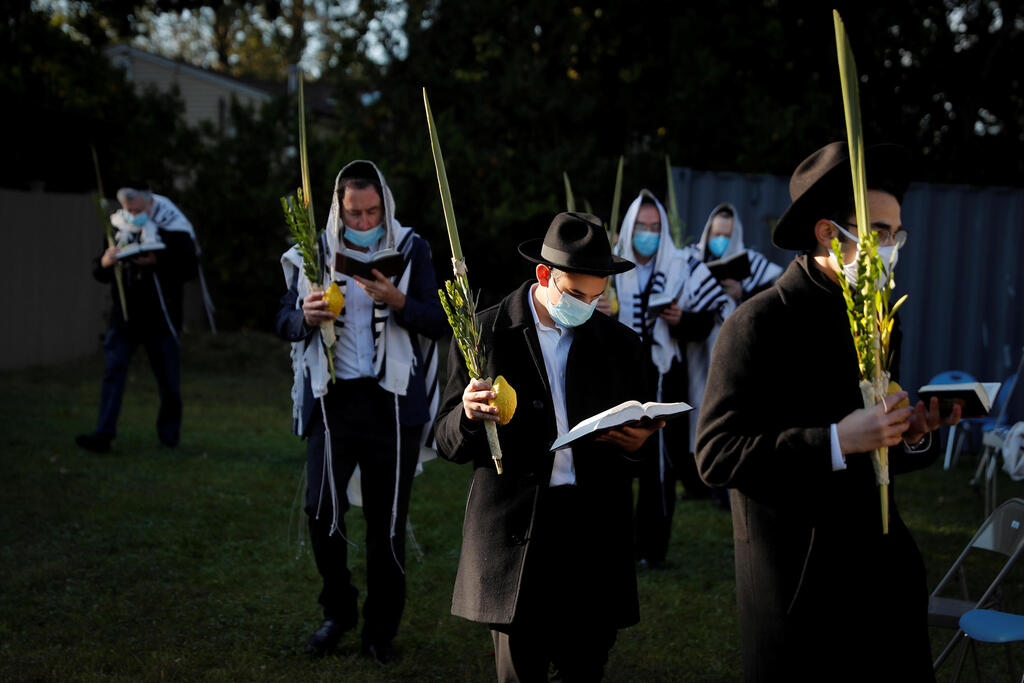 Orthodox Jews gather for "Hoshanot prayers" as part of their Sukkot observance on a neighborhood lawn to avoid over-crowding at an indoor synagogue, following the outbreak of the coronavirus disease (COVID-19) in the New York City suburb of Monsey 