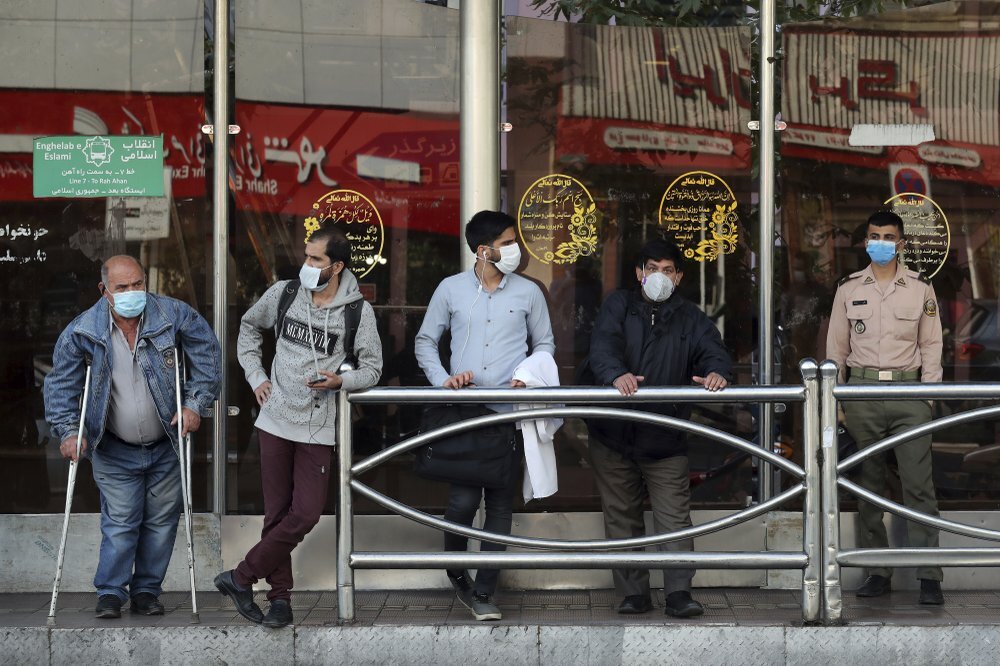 People wear protective face masks to help prevent the spread of the coronavirus in downtown Tehran 