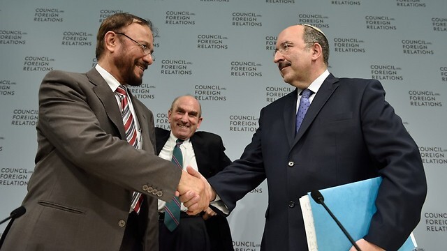 Saudi Maj. Gen. (ret.) Anwar Eshki shakes hands with then-Foreign Ministry chief Dore Gold after sharing the stage at a conference in Washington in 2015 