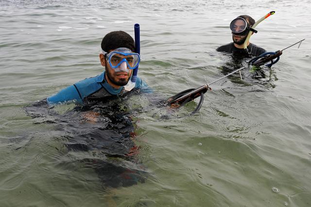 Palestinian spear-fisherman Ashraf Al-Amoudi prepares to dive underwater at the Mediterranean Sea off the coast of the southern Gaza Strip 