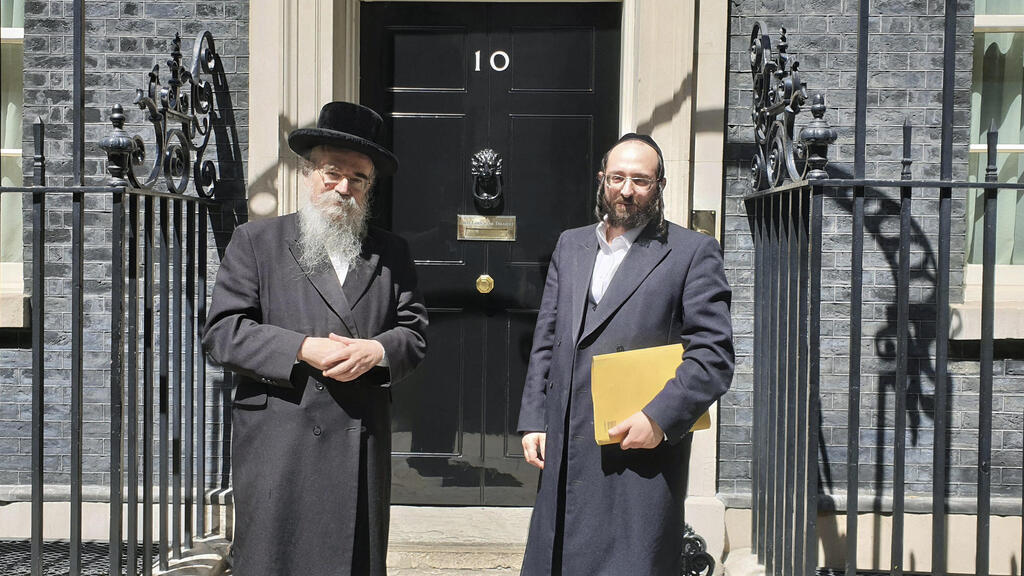 Rabbi Avrohom Pinter, left, stands beside Joel Friedman, right, the director of Public Affairs for the Interlink Foundation, an umbrella organization for Orthodox Jewish charities on July 4, 2019 in Downing Street, London 