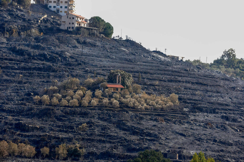 A picture taken on October 11, 2020, shows a church in the middle of a scorched hillside due to forest fires in the countryside of the Syrian western city of Tartus. Dozens of fires that ravaged parts of Syria and Lebanon in recent days were brought under control, authorities in the two countries said 