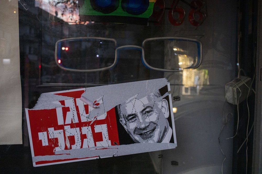A poster reads "closed because of me " with an image of Israel's Prime Minister Benjamin Netanyahu on a closed shop in Tel Aviv, Israel 