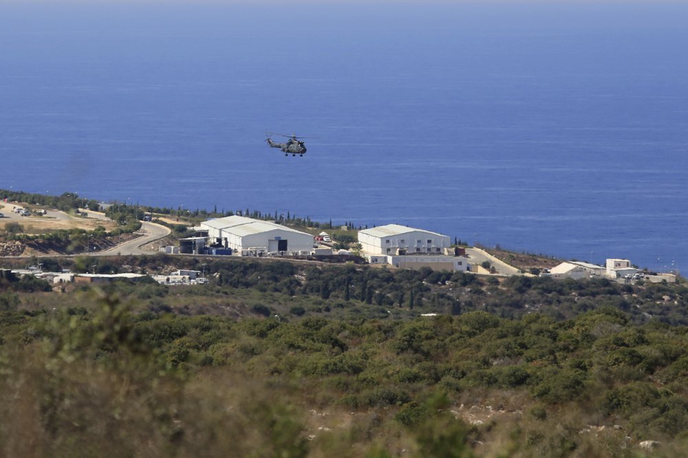 A helicopter flies over a base of the U.N. peacekeeping force, in the southern town of Naqoura, Lebanon 