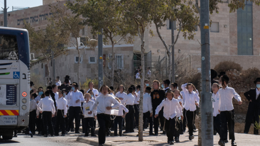 Children bussed to school in West Bank settlement of Beitar Illit 