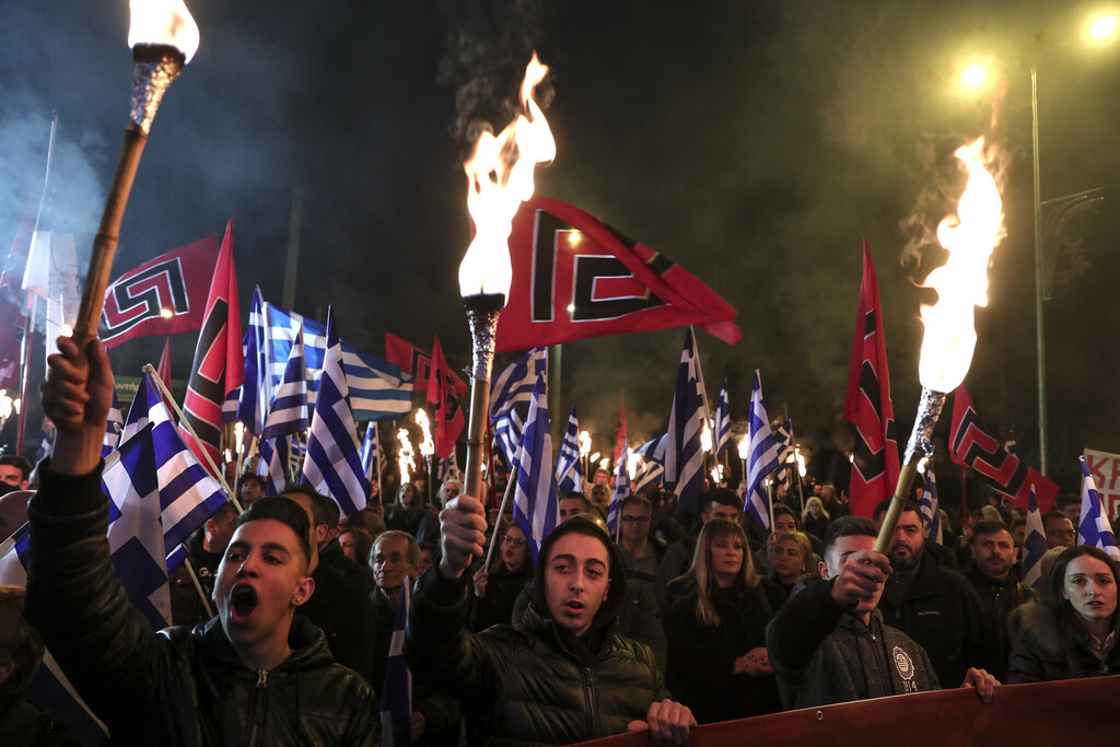 Supporters of Greece's extreme right Golden Dawn raise torches during a rally in Athens 