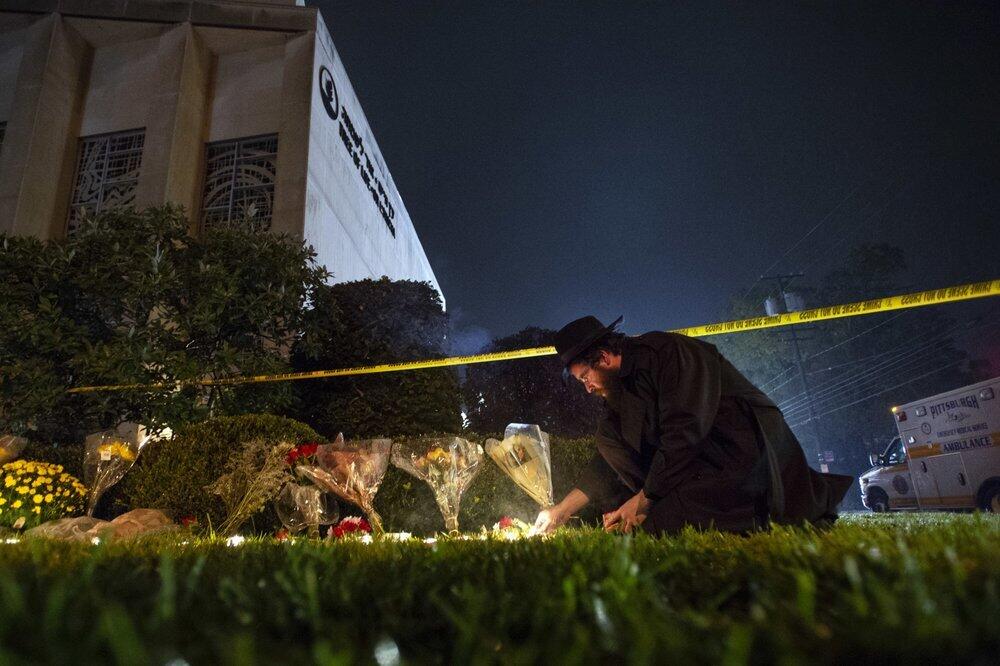 Rabbi Eli Wilansky lights a candle after a mass shooting at Tree of Life Synagogue in Pittsburgh's Squirrel Hill neighborhood 