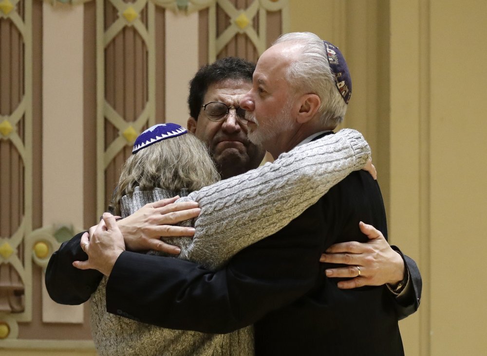 Rabbi Jeffrey Myers, right, of Tree of Life/Or L'Simcha Congregation hugs Rabbi Cheryl Klein, left, of Dor Hadash Congregation and Rabbi Jonathan Perlman during a community gathering held in the aftermath of a deadly shooting at the Tree of Life Synagogue in Pittsburgh 