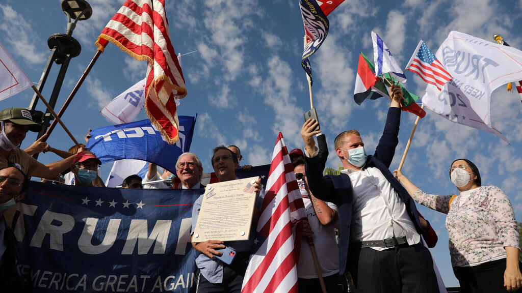 Israeli supporters of US President Donald Trump wave flags as they drive on a Highway on their way from Tel Aviv to Jerusalem, Israel, 27 October 2020 