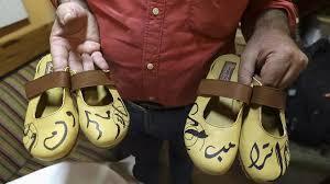 Handcrafted footwear with the names of the US and French presidents in Arabic calligraphy to show disapproval of them