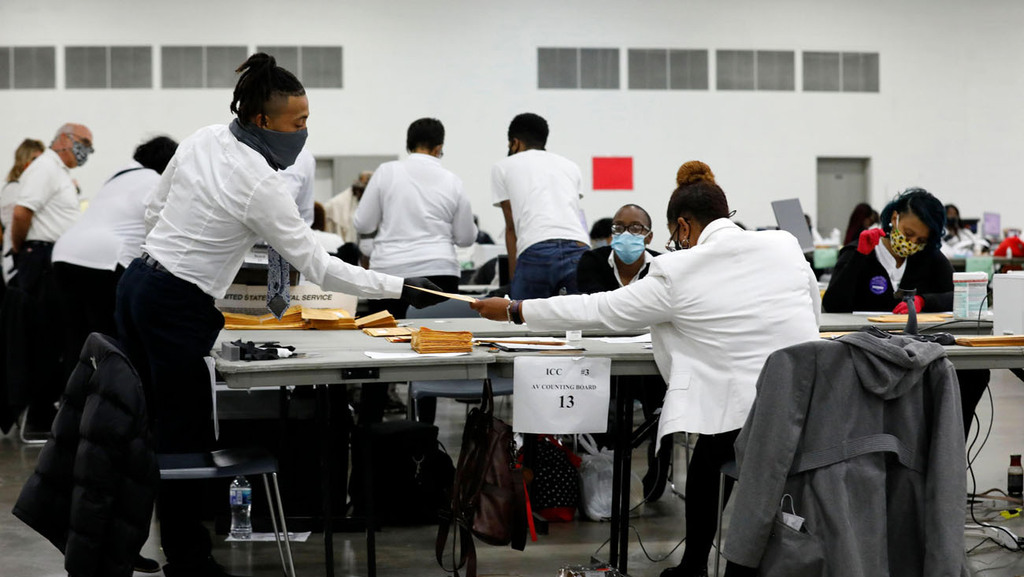 עובדי הבחירות ב דטרויט עובדים על ספירת פתקי הצבעה נפקדים לבחירות הכלליות 2020 במרכז TCF בדטרויט מישיגן