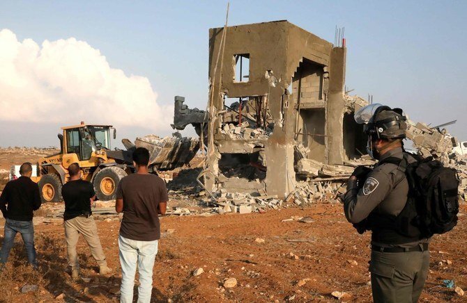 Israeli machinery demolish a Palestinian house located within the area C (where Israel retains control, including over planning and construction) near Yatta in the southern area of the West Bank town of Hebron 