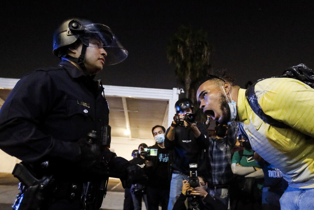 A man yells at a police officer during a protest on Election Day,
