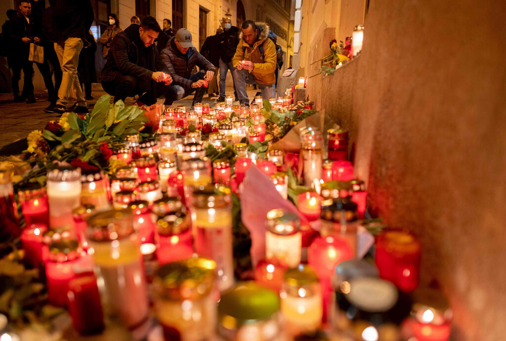 People light up candles outside Vienna's main synagogue near the site of the terrorist attack in Vienna, Austria on November 4, 2020 