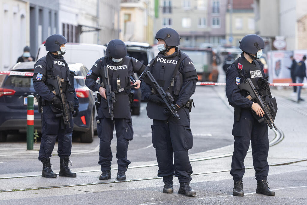Armed Austrian police officers during a raid at a mosque in Vienna, Austria