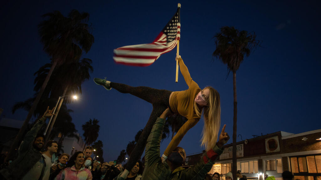  People dance in the Venice Beach neighborhood of Los Angeles, California as they celebrate after Joe Biden was declared winner of the 2020 presidential election