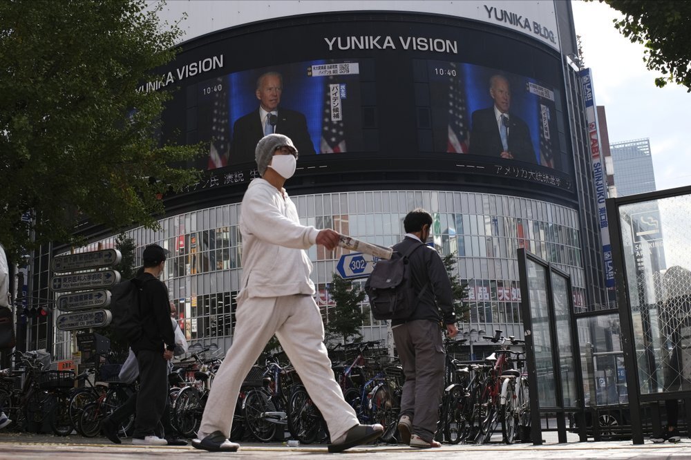 A screen shows live broadcast of President-elect Joe Biden speaking Sunday, Nov. 8, 2020 at the Shinjuku shopping district in Tokyo 