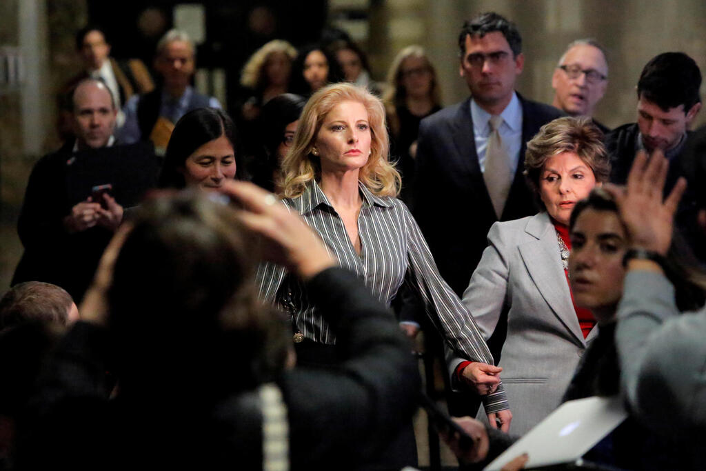 Summer Zervos, a former contestant on The Apprentice, leaves New York State Supreme Court with attorney Gloria Allred (R) after a hearing on the defamation case against U.S. President Donald Trump 
