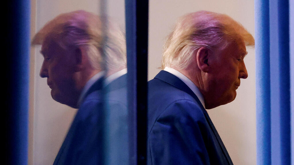 U.S. President Donald Trump is reflected as he departs after speaking about the 2020 U.S. presidential election results in the Brady Press Briefing Room at the White House in Washington 