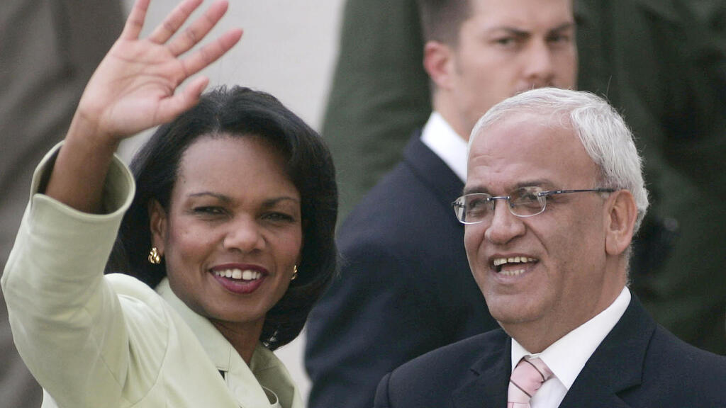 Saeb Erakat stands next to then-U.S. Secretary of State Condoleezza Rice in the West Bank city of Ramallah, Oct. 2007 