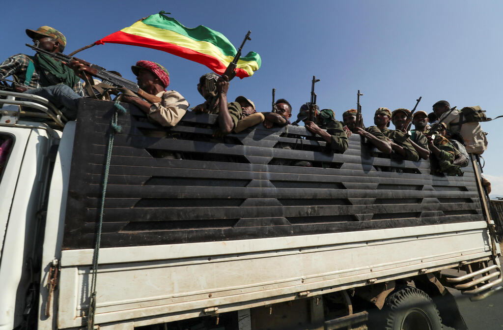 Members of Amhara region militias ride on their truck as they head to face the Tigray People's Liberation Front (TPLF), in Sanja, Amhara region near a border with Tigray, Ethiopia 