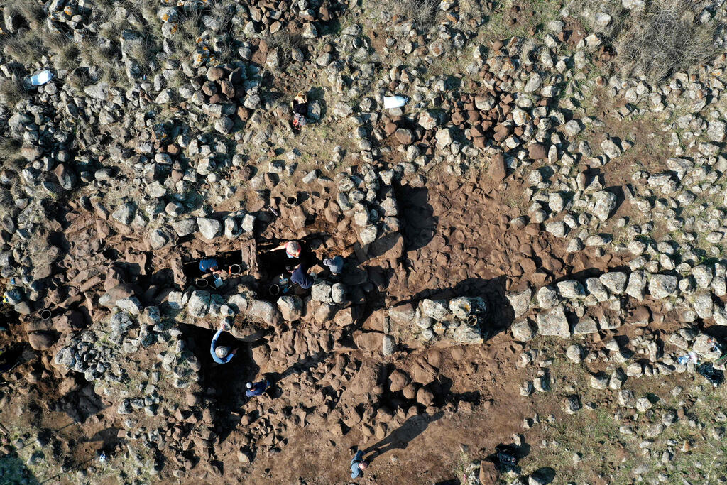 An aerial picture shows Israel Antiquities Authority (IAA) archeologists working at a fortified complex from the time of King David which was exposed for the first time in archaeological excavations carried out by IAA in the Hispin settlement in the Israeli-annexed Golan Heights 