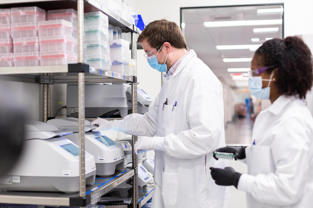 Researchers work in a lab run by Moderna Inc 