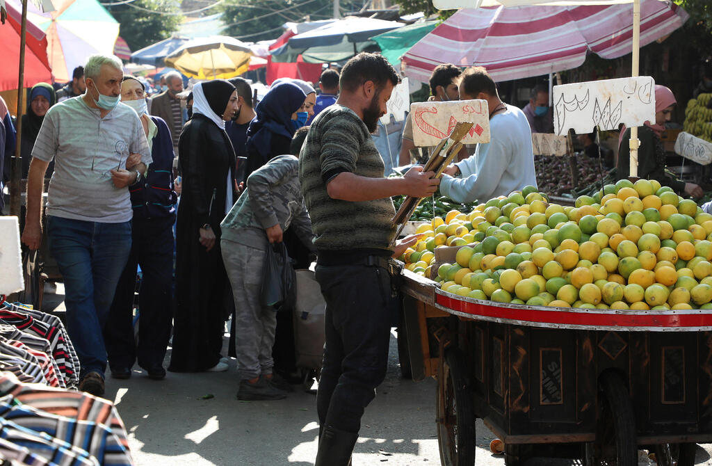 People shop at a crowded souk as the Lebanese government ordered a national lockdown, to combat a resurgence of the coronavirus disease (COVID-19) outbreak, in Sabra, Beirut suburbs, Lebanon 
