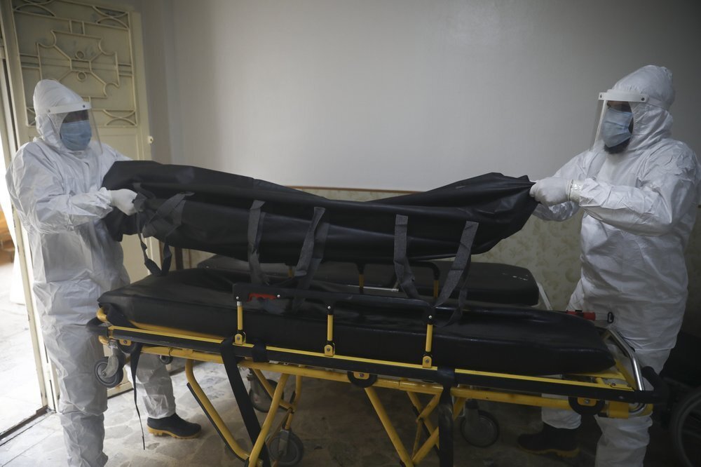 Civil defense personnel take the body of a person who died of corona virus from a hospital in Idlib, Syria 
