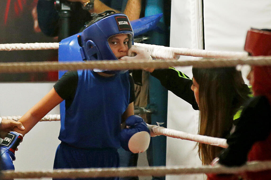 A Palestinian girl takes part in a rare boxing championship in Gaza City 