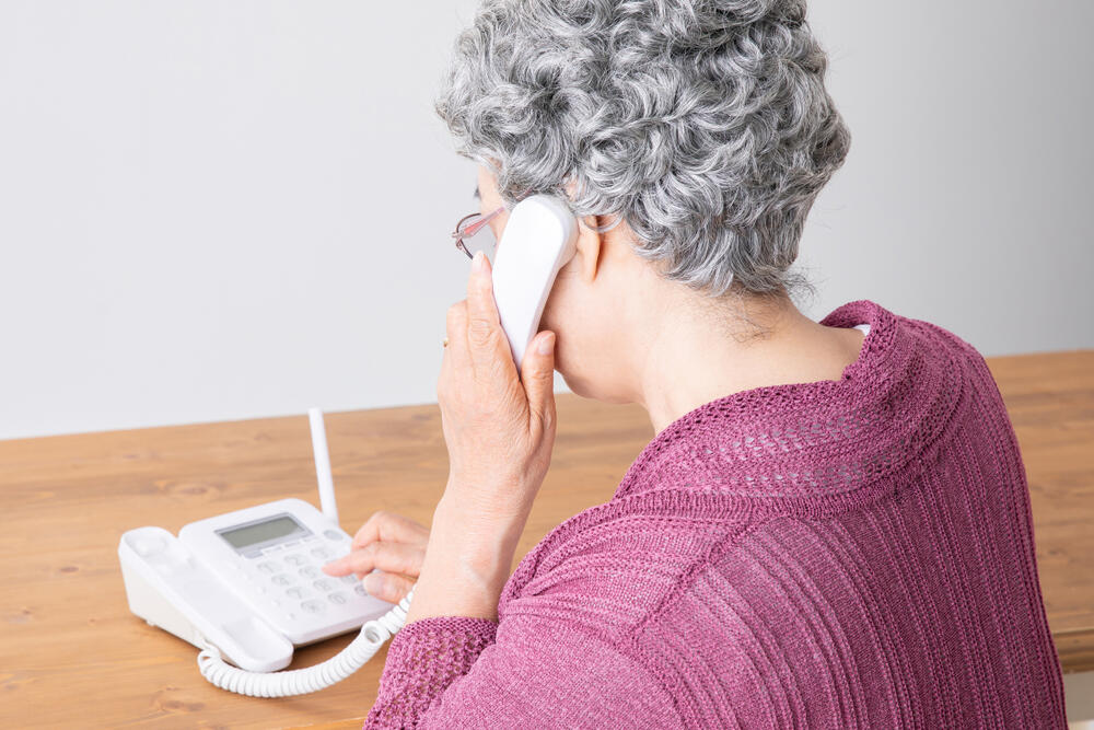 An elderly woman using a phone/illustration 